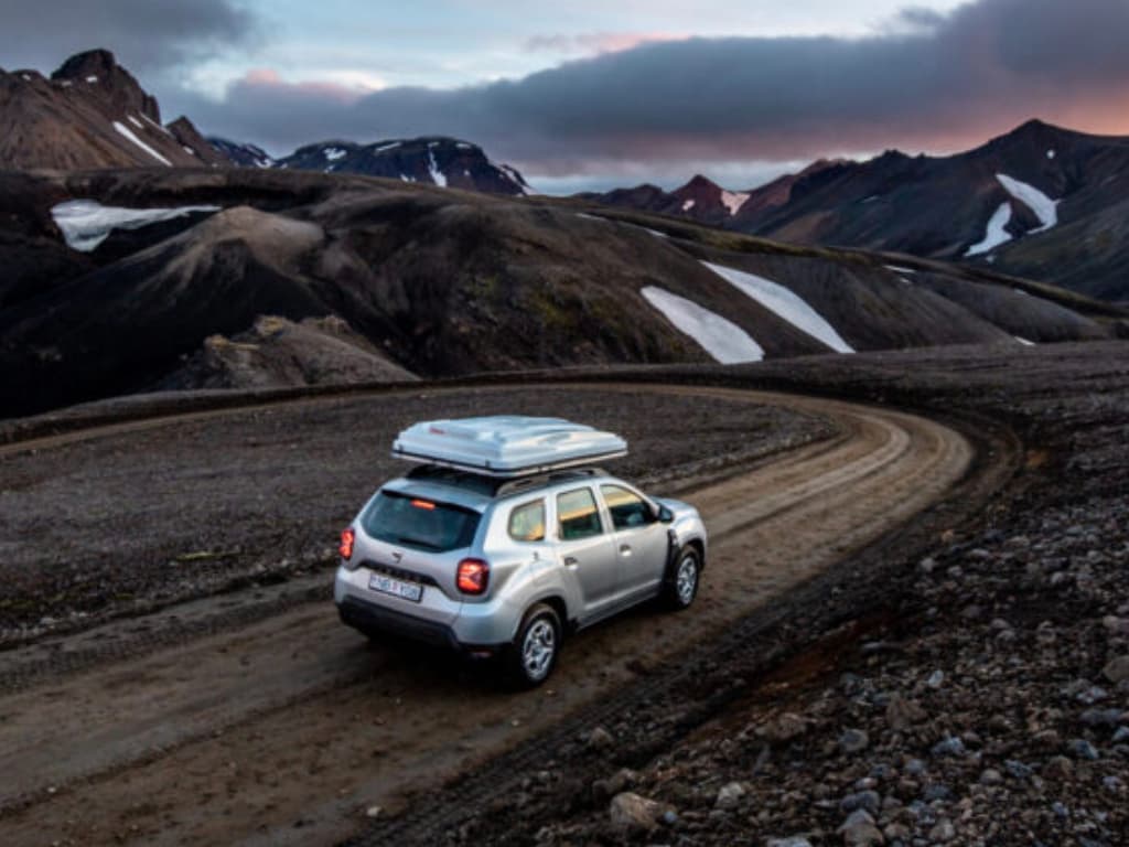 4x4 campervan on a gravel road through the Icelandic highlands at twilight